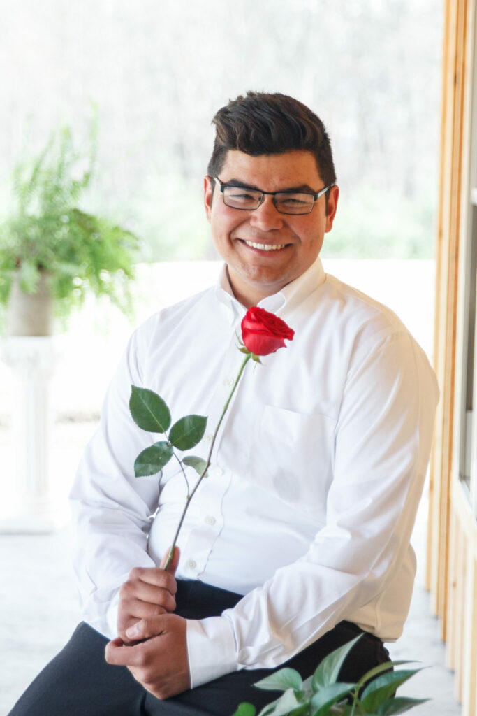 Camper dressed up holding rose for mom