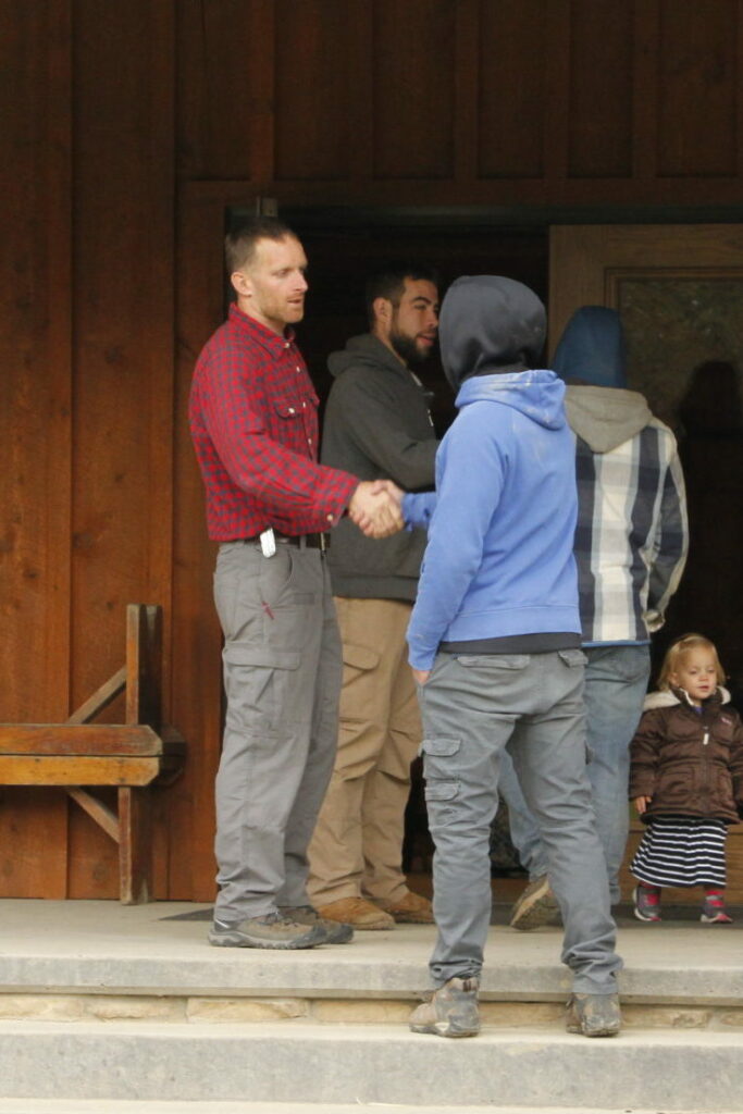 supervisors shaking boys hands as they enter chuckwagon